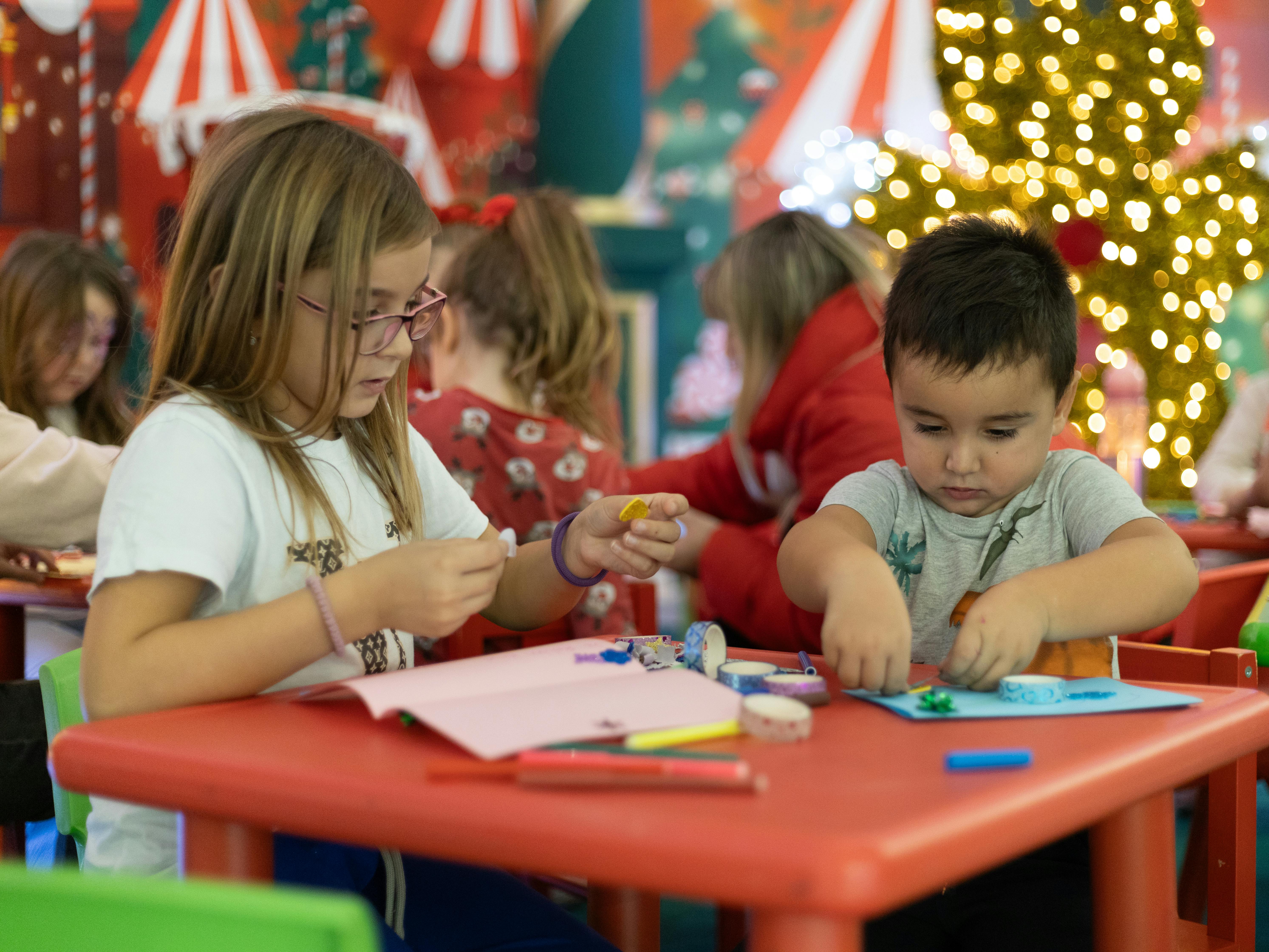 Children taking part in Christmas arts and crafts activity at HAF holiday club in school